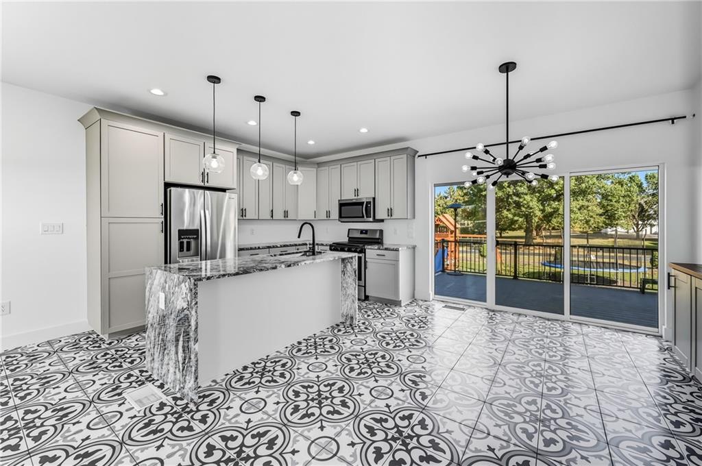 5237 Virginia Road Hermitage, PA 16148 - Photo 8 of 49 a kitchen with stainless steel appliances granite countertop a refrigerator and a sink