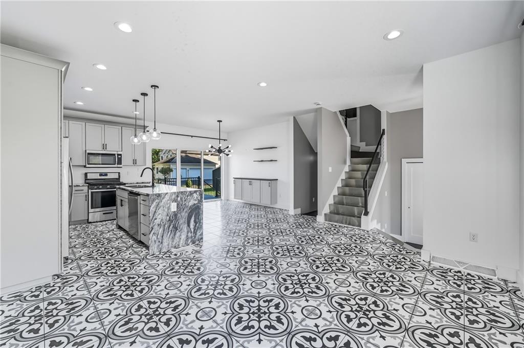 5237 Virginia Road Hermitage, PA 16148 - Photo 10 of 49 a kitchen with stainless steel appliances kitchen island granite countertop a refrigerator and a stove top oven