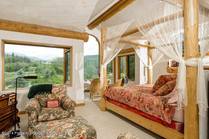 3768 Snowmass Creek Road Snowmass, CO 81654 - Photo 12 of 28 a bedroom with furniture and large windows