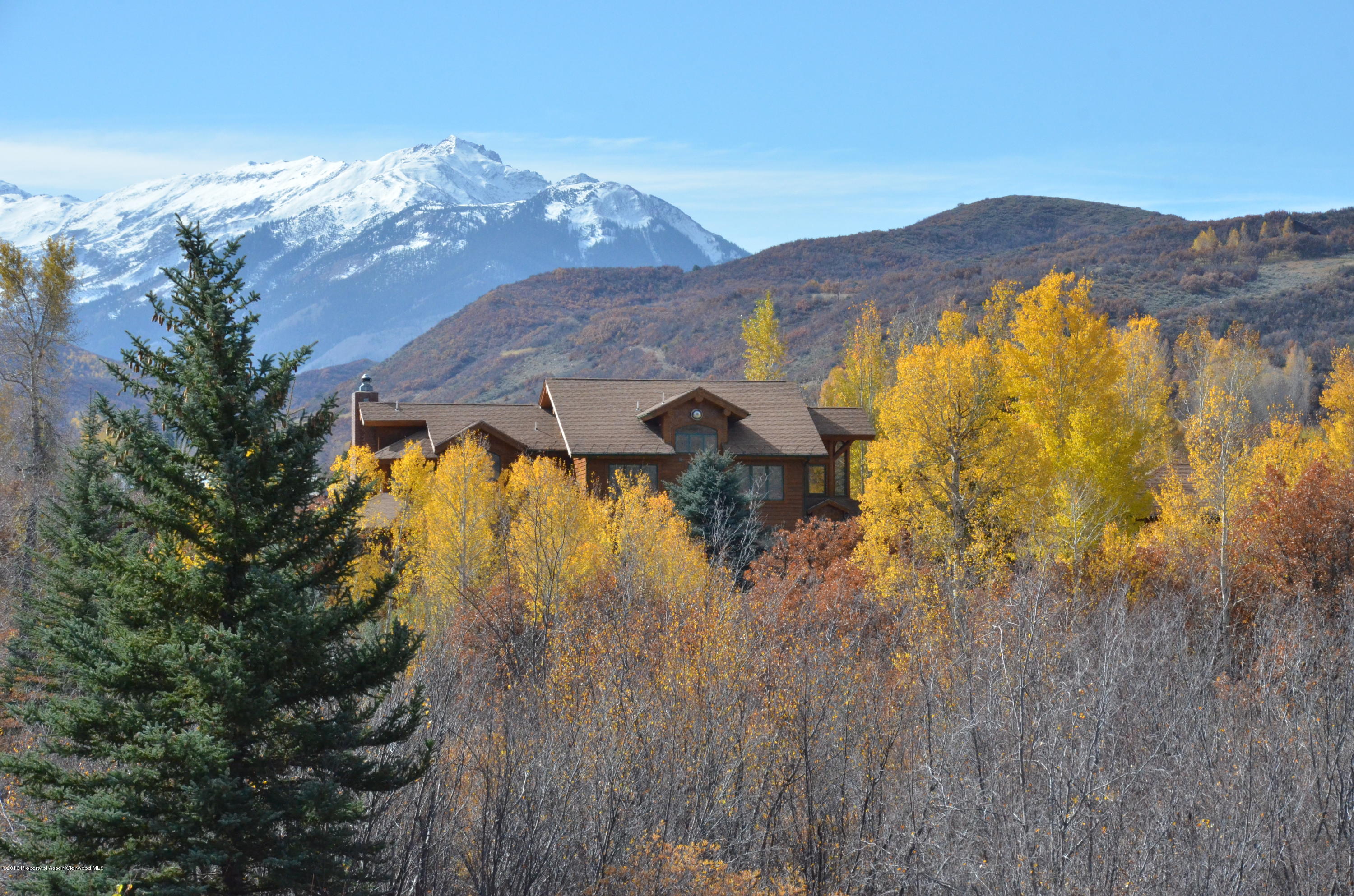 3768 Snowmass Creek Road Snowmass, CO 81654 - Photo 13 of 28 a view of a house with a mountain and a forest