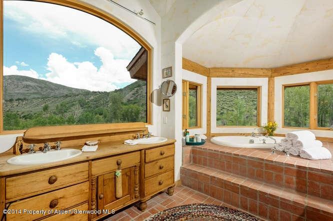 3768 Snowmass Creek Road Snowmass, CO 81654 - Photo 16 of 28 a spacious bathroom with a double vanity sink and a large mirror