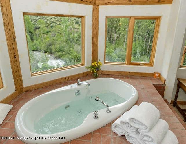 3768 Snowmass Creek Road Snowmass, CO 81654 - Photo 18 of 28 a bathroom with a tub and large window