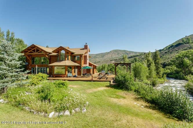 3768 Snowmass Creek Road Snowmass, CO 81654 - Photo 2 of 28 a view of a big house with a big yard and large trees