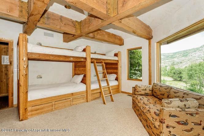 3768 Snowmass Creek Road Snowmass, CO 81654 - Photo 28 of 28 a bedroom with furniture and large window