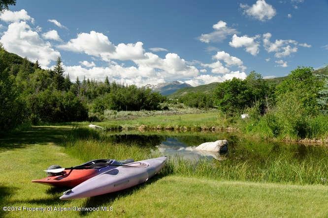 3768 Snowmass Creek Road Snowmass, CO 81654 - Photo 7 of 28 a view of a lake with houses in the back
