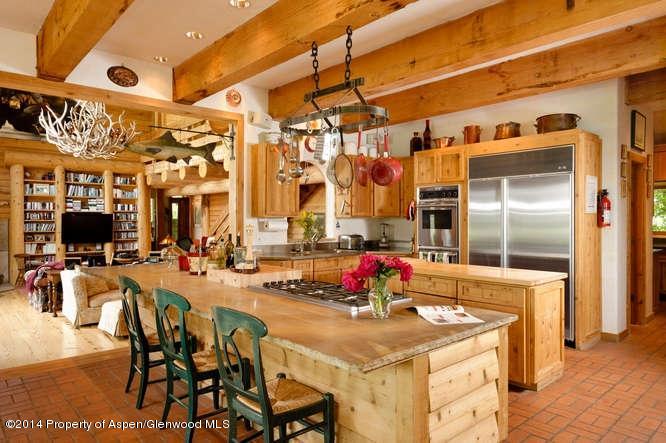 3768 Snowmass Creek Road Snowmass, CO 81654 - Photo 8 of 28 a view of a dining area with furniture and a chandelier