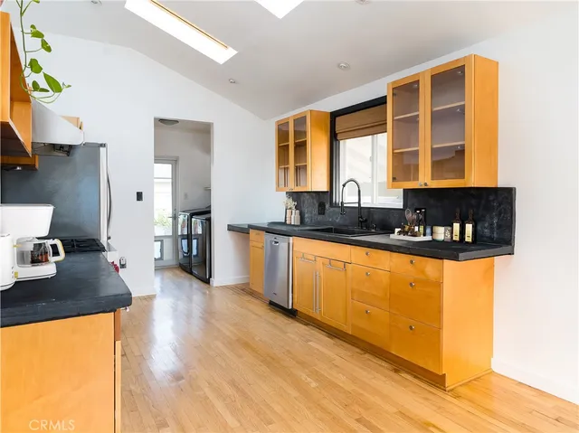 a kitchen with granite countertop a sink and a wooden floor
