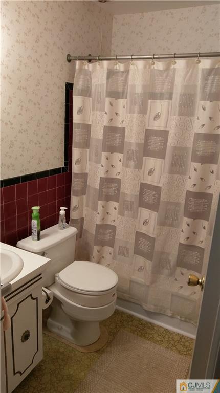 41 Winthrop Road Edison, NJ 08817 - Photo 14 of 18 a white toilet sitting next to a bathroom sink