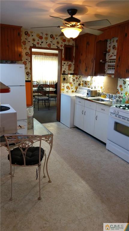 41 Winthrop Road Edison, NJ 08817 - Photo 15 of 18 a kitchen with stainless steel appliances kitchen island granite countertop a table and chairs in it