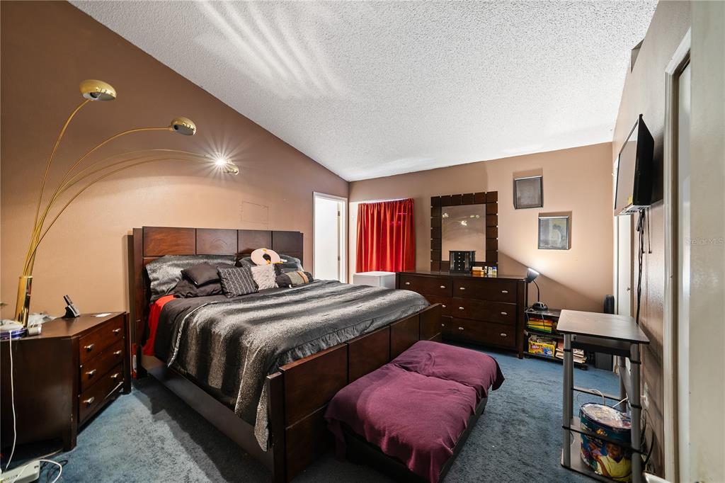 5624 Indialantic Drive Orlando, FL 32808 - Photo 12 of 17 a bedroom with a bed and wooden floor