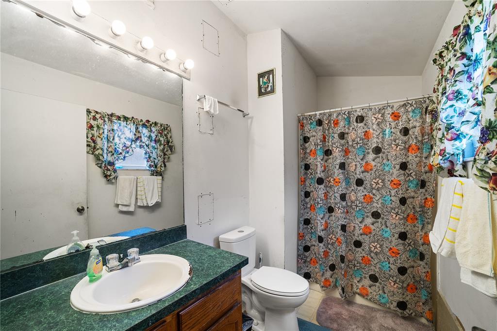 5624 Indialantic Drive Orlando, FL 32808 - Photo 14 of 17 a bathroom with a sink toilet and a mirror