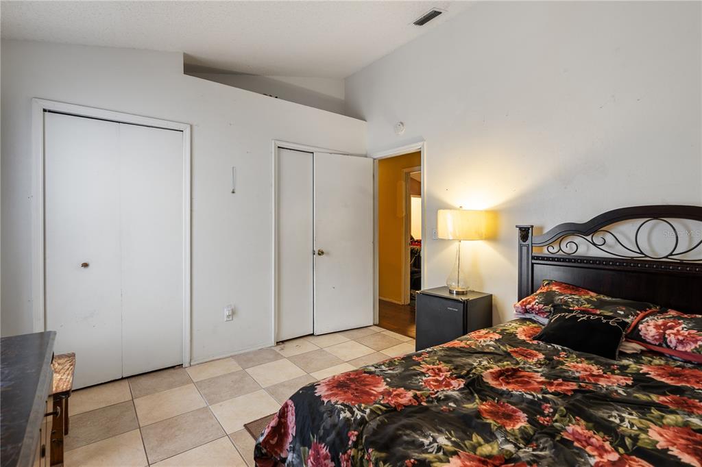 5624 Indialantic Drive Orlando, FL 32808 - Photo 15 of 17 a bedroom with a bed and a closet