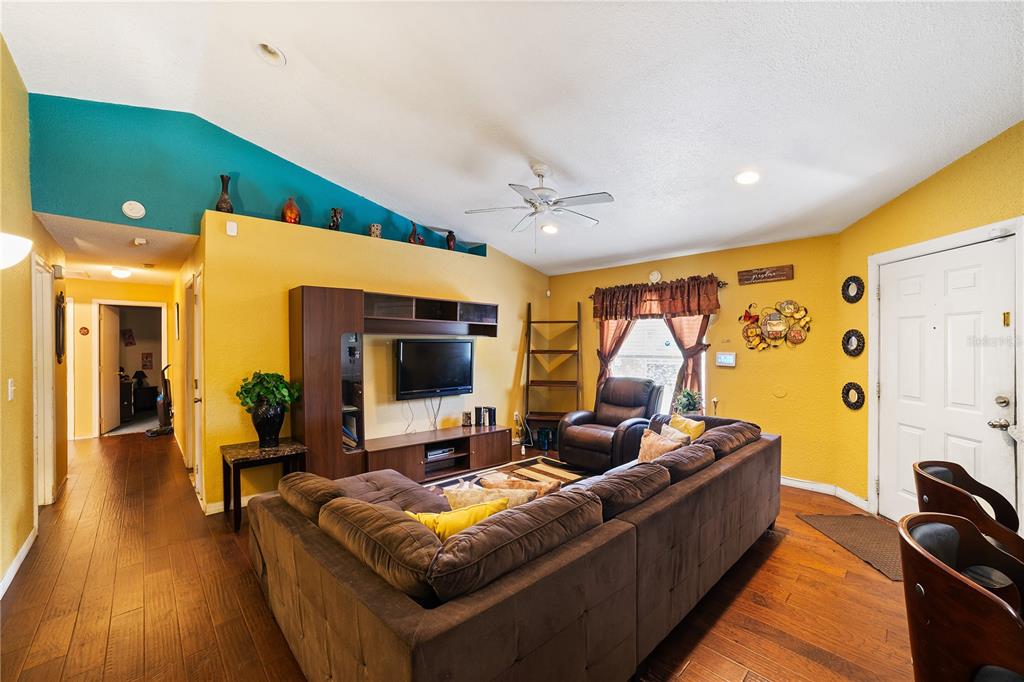 5624 Indialantic Drive Orlando, FL 32808 - Photo 2 of 17 a living room with furniture and a flat screen tv