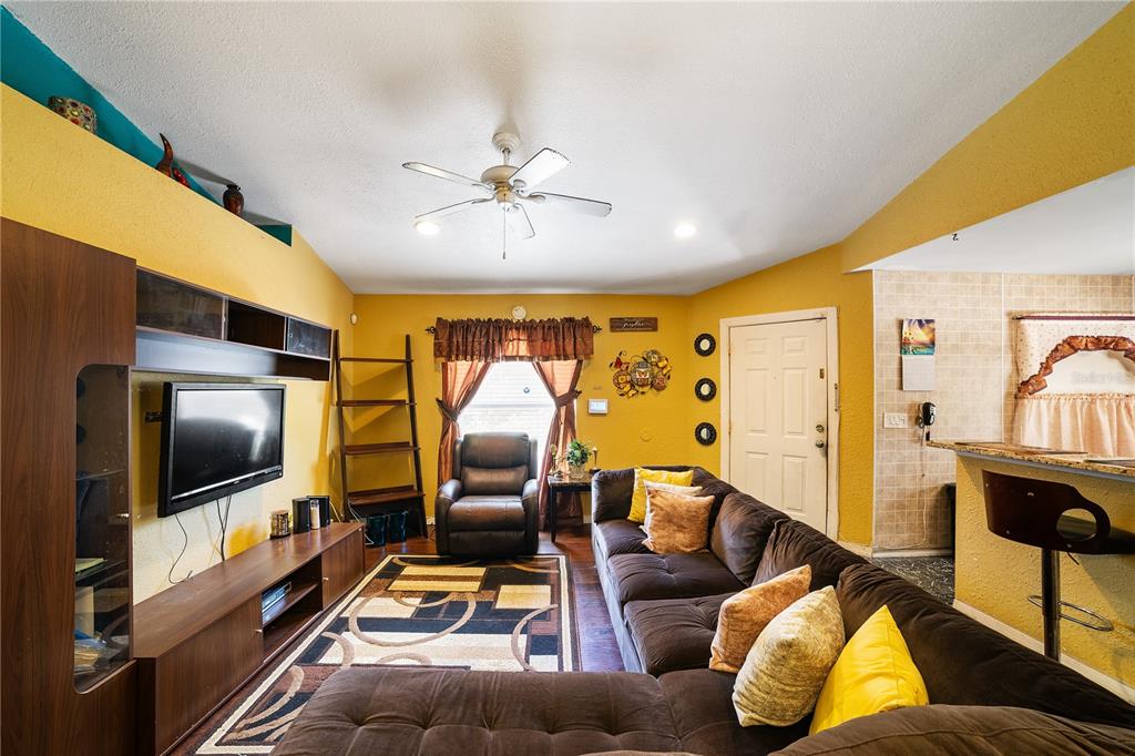 5624 Indialantic Drive Orlando, FL 32808 - Photo 4 of 17 a living room with furniture and a flat screen tv