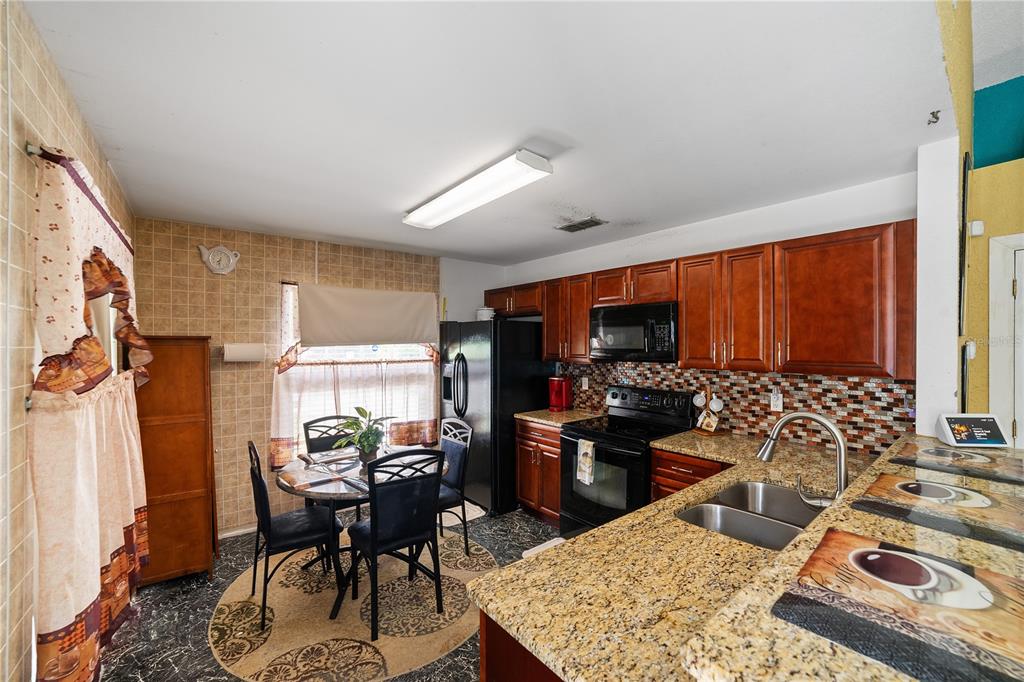 5624 Indialantic Drive Orlando, FL 32808 - Photo 7 of 17 a view of a dining room with furniture window and outside view