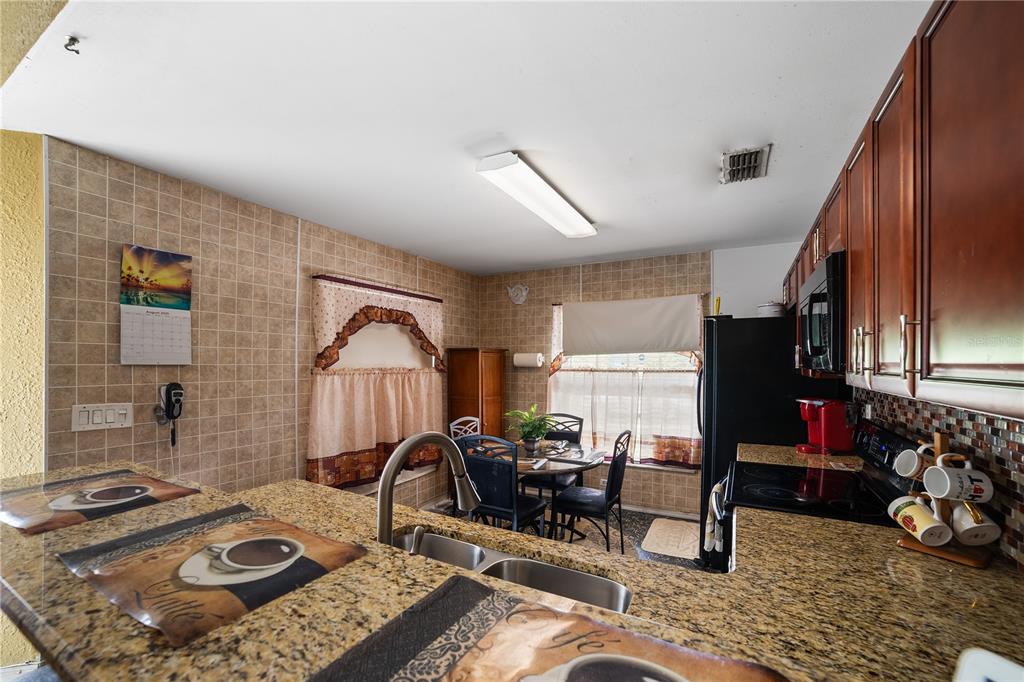 5624 Indialantic Drive Orlando, FL 32808 - Photo 8 of 17 a living room with furniture and a window