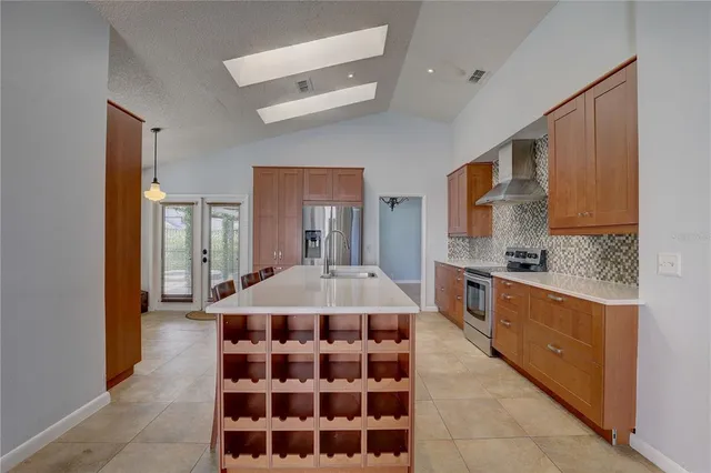 a large kitchen with kitchen island stainless steel appliances a sink and counter space