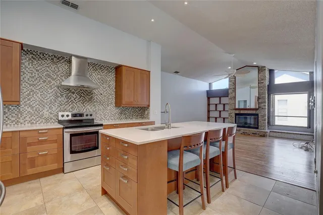 a kitchen with stainless steel appliances kitchen island granite countertop a sink and cabinets
