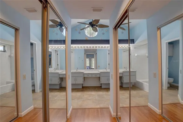 a spacious bathroom with a glass shower door and a sink