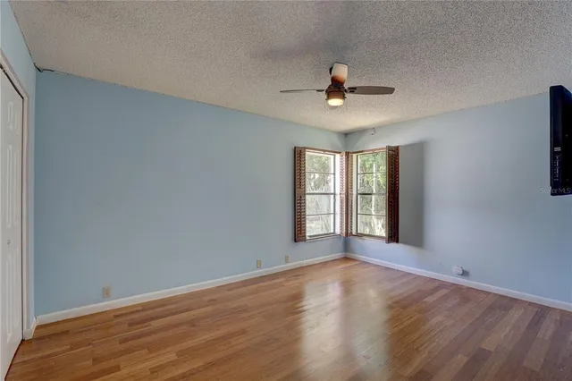 a view of a livingroom with a window and wooden floor