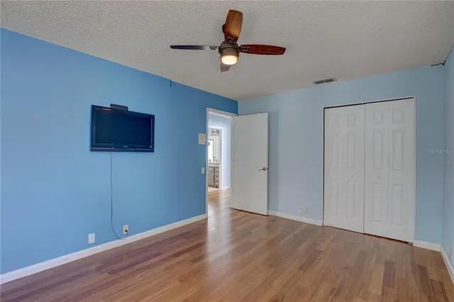 a view of a livingroom with wooden floor and a window