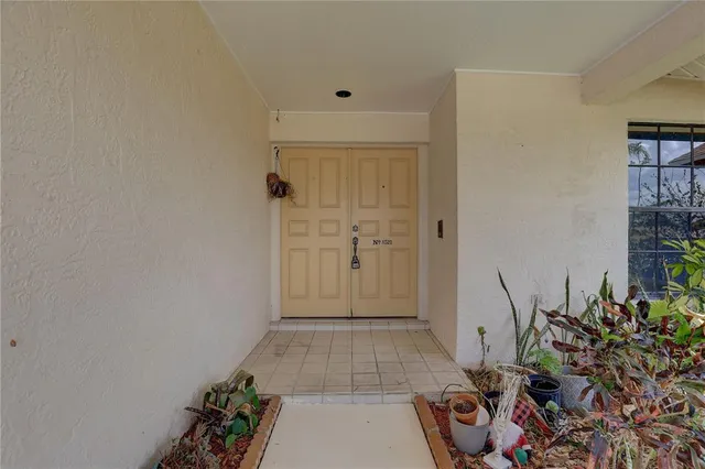 wooden floor with potted plants in front of door