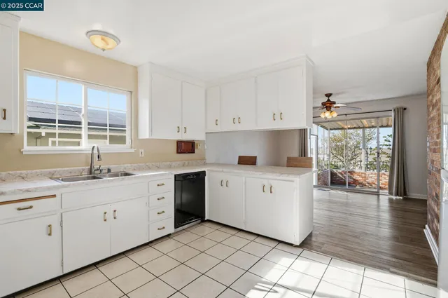 a kitchen with sink and cabinets