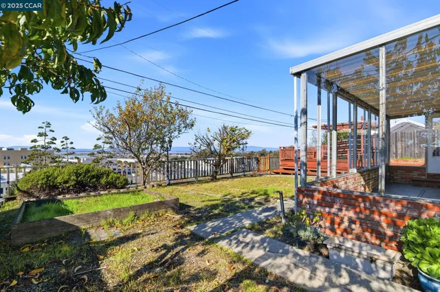 a view of a backyard with plants and a garden