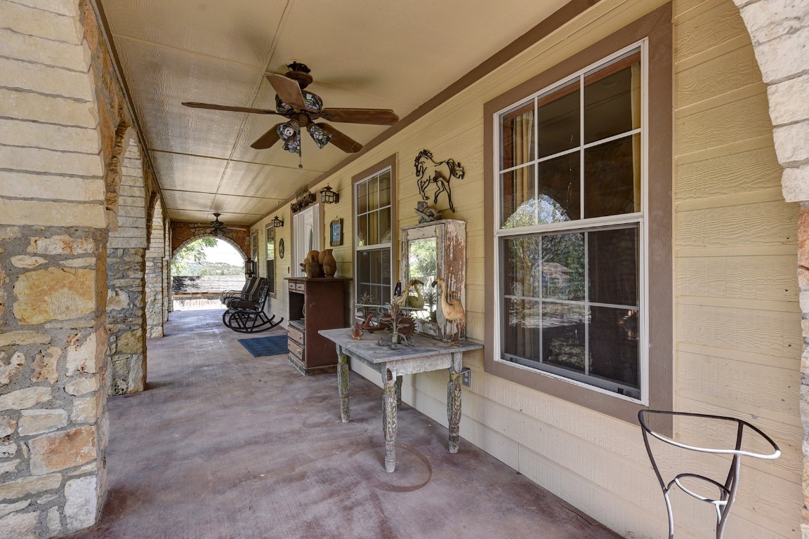 4525 Bell Springs Road Dripping Springs, TX 78620 - Photo 22 of 38 a view of a porch with furniture and a gate