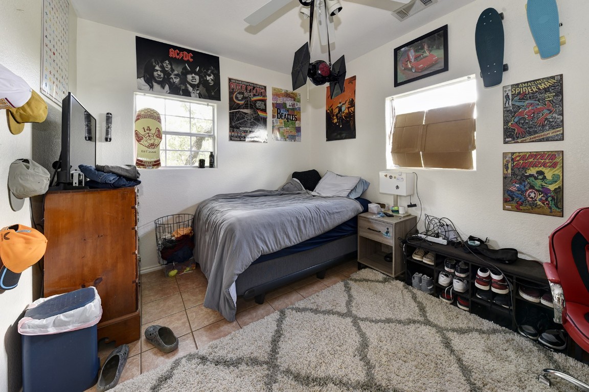 4525 Bell Springs Road Dripping Springs, TX 78620 - Photo 30 of 38 a bedroom with a bed and wooden floor