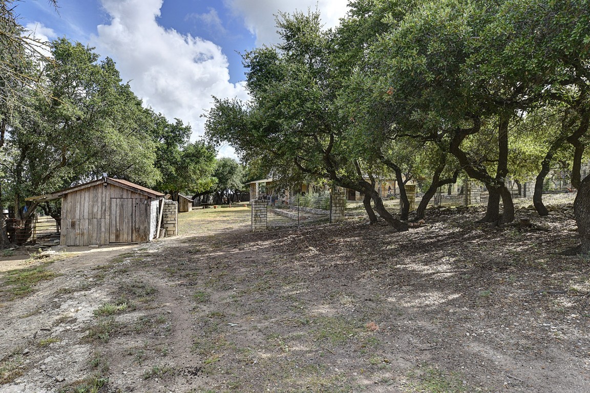 4525 Bell Springs Road Dripping Springs, TX 78620 - Photo 38 of 38 a view of backyard with large trees and wooden fence