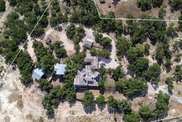 an aerial view of a house with a yard