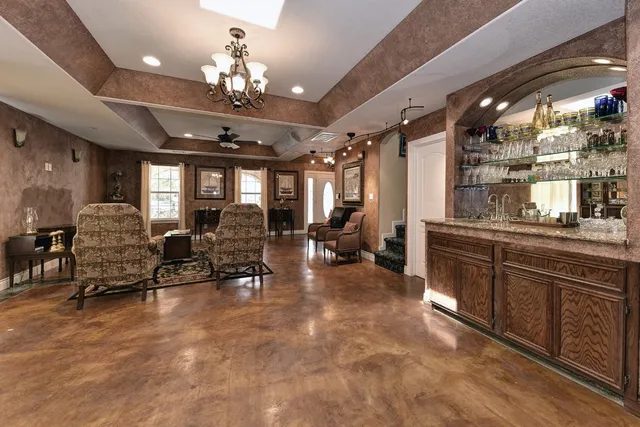 a large room with lots of furniture and chandelier