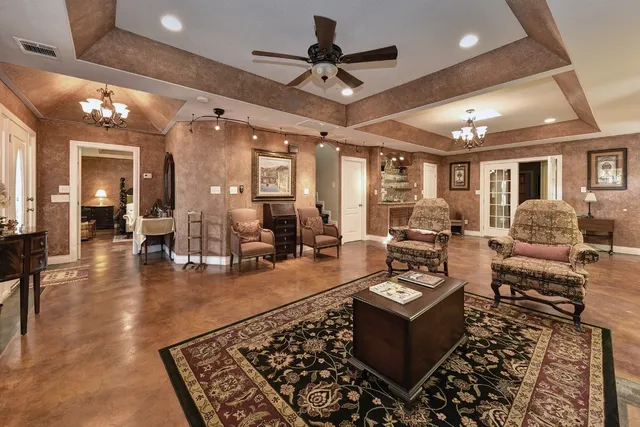 a living room with furniture and a chandelier