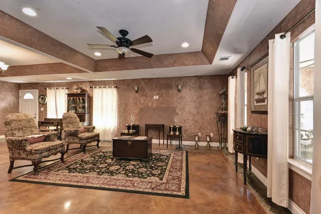 a living room with furniture and a large window