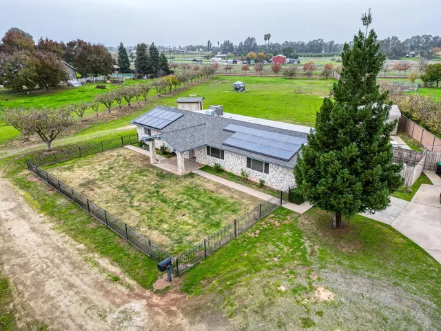 an aerial view of a house with outdoor space tennis court