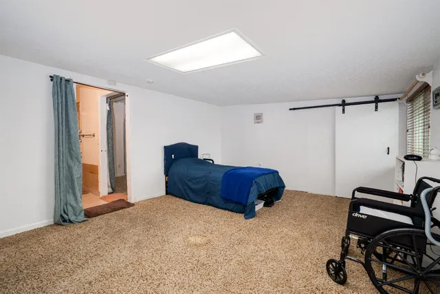 a bedroom with a bed and a window