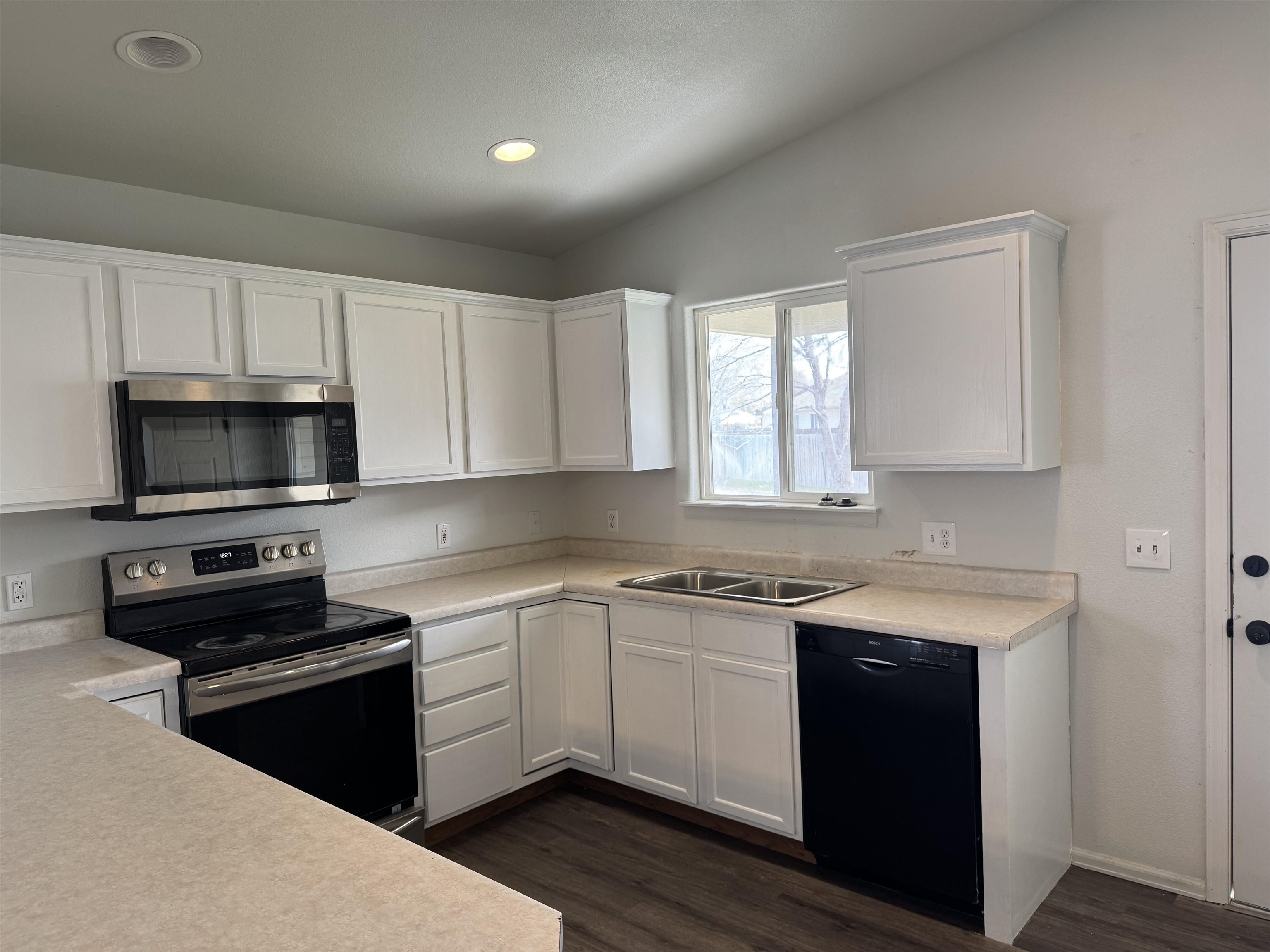 516 Vermont Lane Fruita, CO 81521 - Photo 3 of 13 a kitchen with a sink stove and microwave