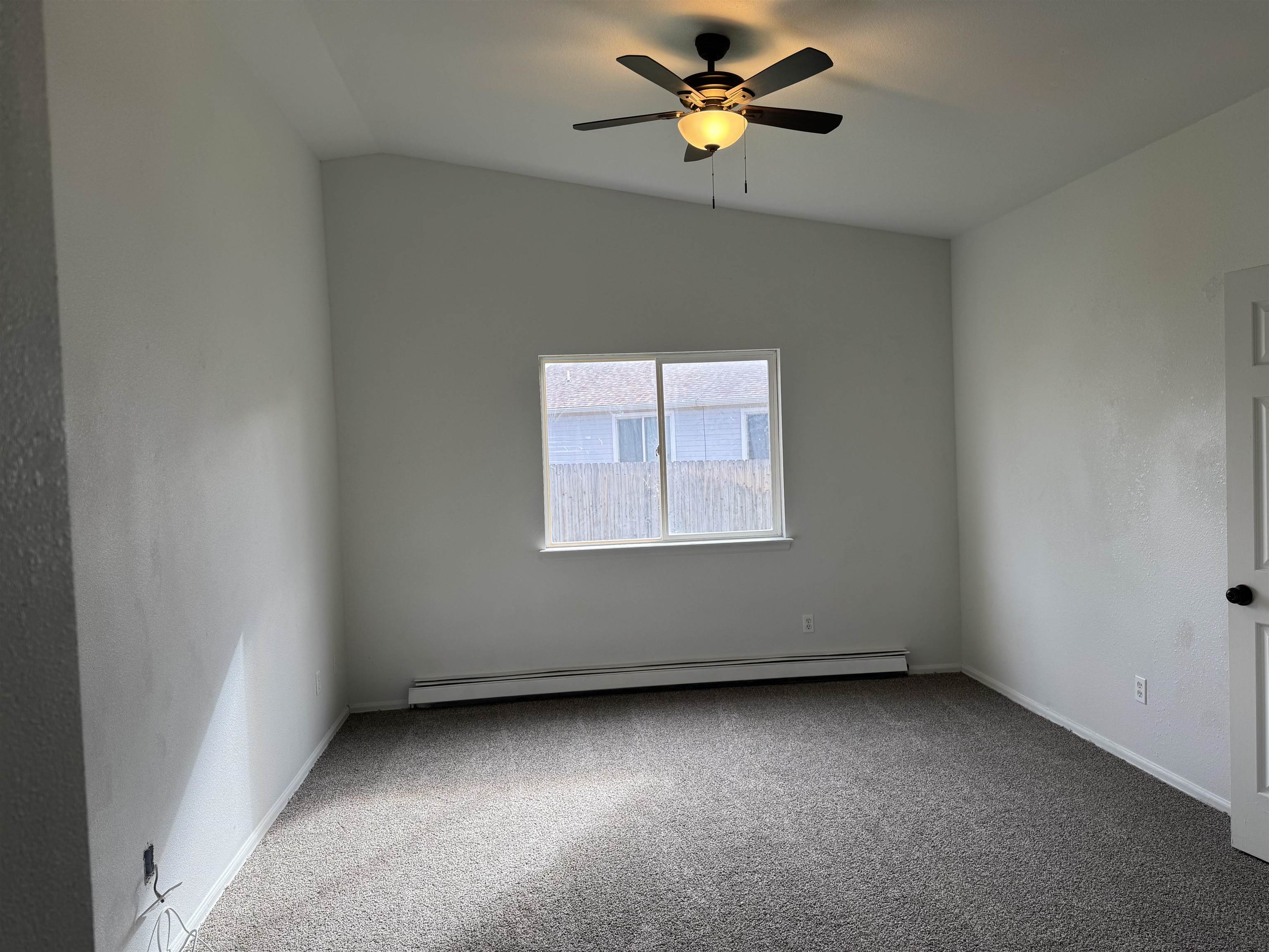 516 Vermont Lane Fruita, CO 81521 - Photo 8 of 13 an empty room with a window and ceiling fan