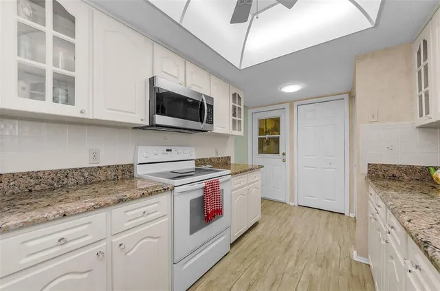 a kitchen with stainless steel appliances granite countertop a stove and a sink