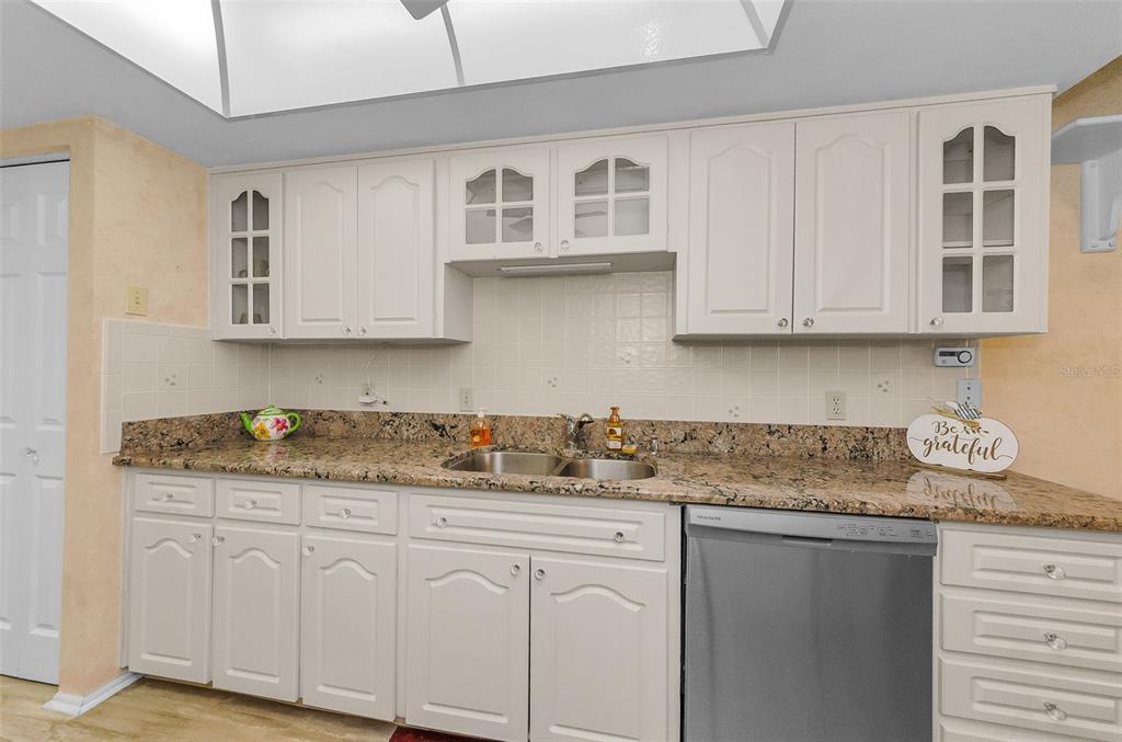 11516 Versailles Lane Port Richey, FL 34668 - Photo 16 of 41 a kitchen with stainless steel appliances granite countertop a sink stove and cabinets