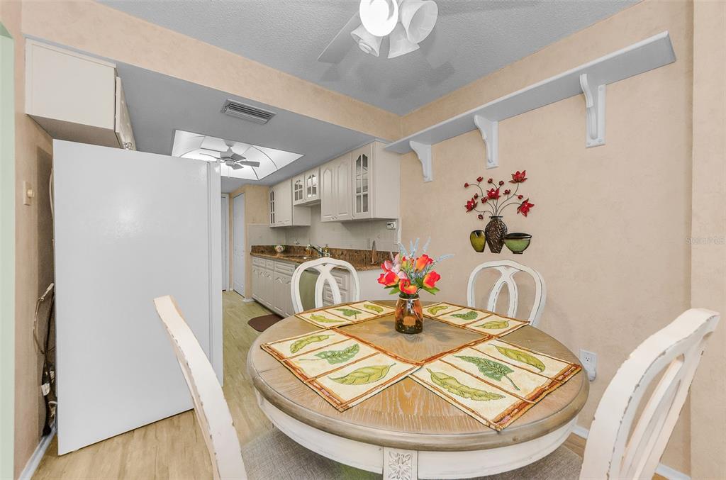 11516 Versailles Lane Port Richey, FL 34668 - Photo 17 of 41 a dining room with wooden floor dining table and chairs