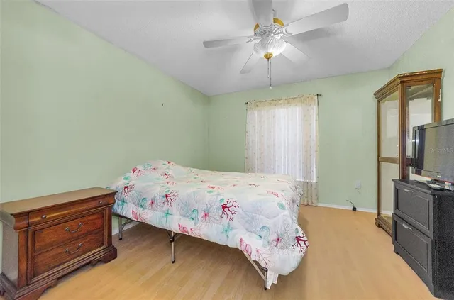 a bedroom with a bed and a chandelier