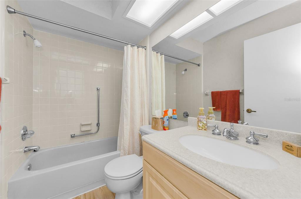 11516 Versailles Lane Port Richey, FL 34668 - Photo 26 of 41 a bathroom with a granite countertop sink a toilet and shower