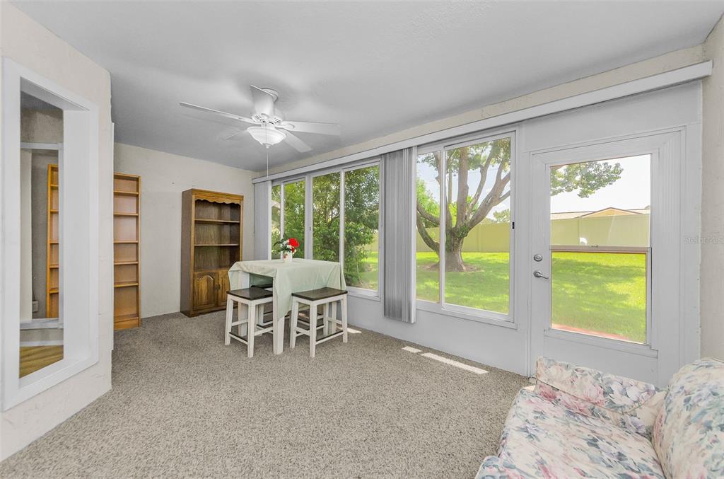 11516 Versailles Lane Port Richey, FL 34668 - Photo 27 of 41 a living room with furniture and a large window