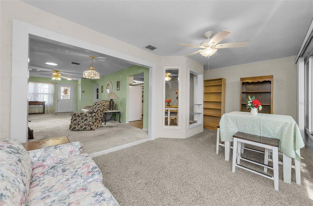 11516 Versailles Lane Port Richey, FL 34668 - Photo 30 of 41 a bed room with a bed and a view of kitchen