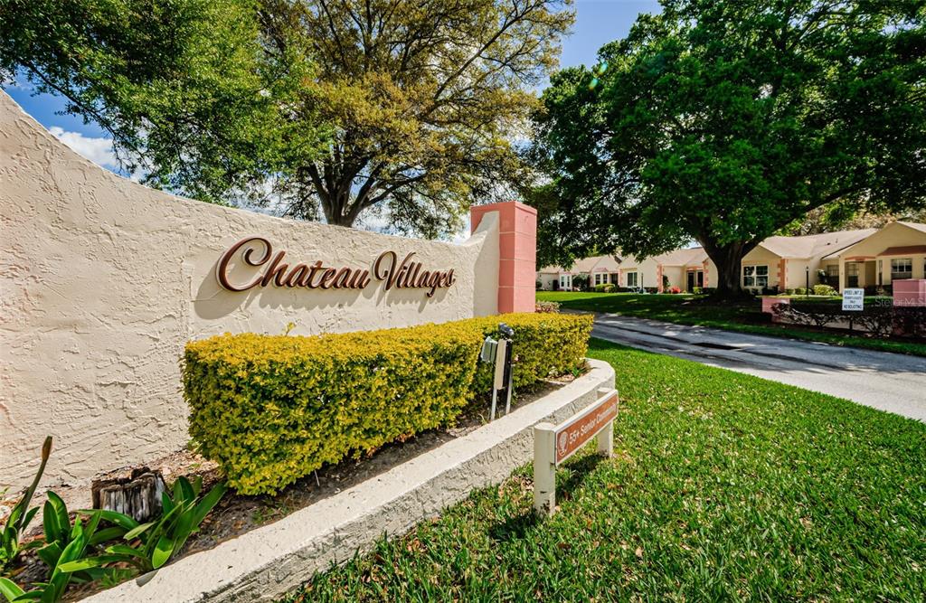 11516 Versailles Lane Port Richey, FL 34668 - Photo 35 of 41 a sign that is sitting on a brick wall