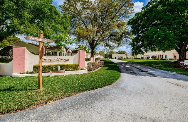 a front view of a house with a yard and trees