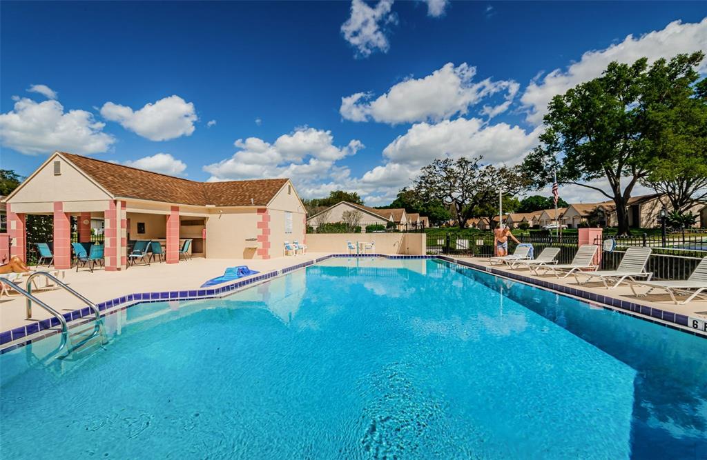 11516 Versailles Lane Port Richey, FL 34668 - Photo 39 of 41 a view of a house with backyard and swimming pool