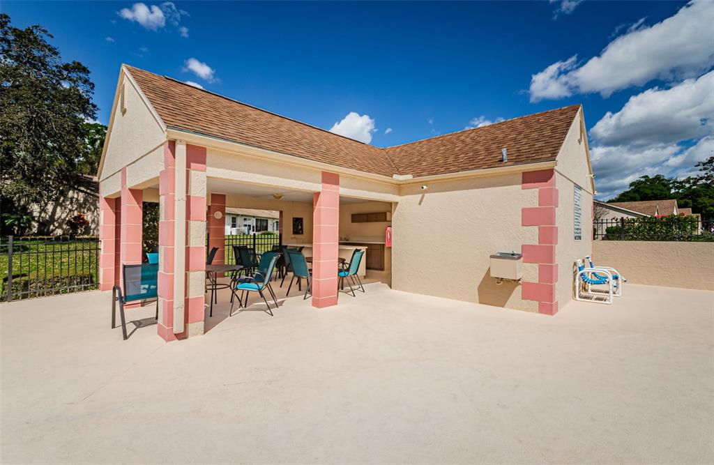 11516 Versailles Lane Port Richey, FL 34668 - Photo 41 of 41 a view of a house with basket ball court and a garage